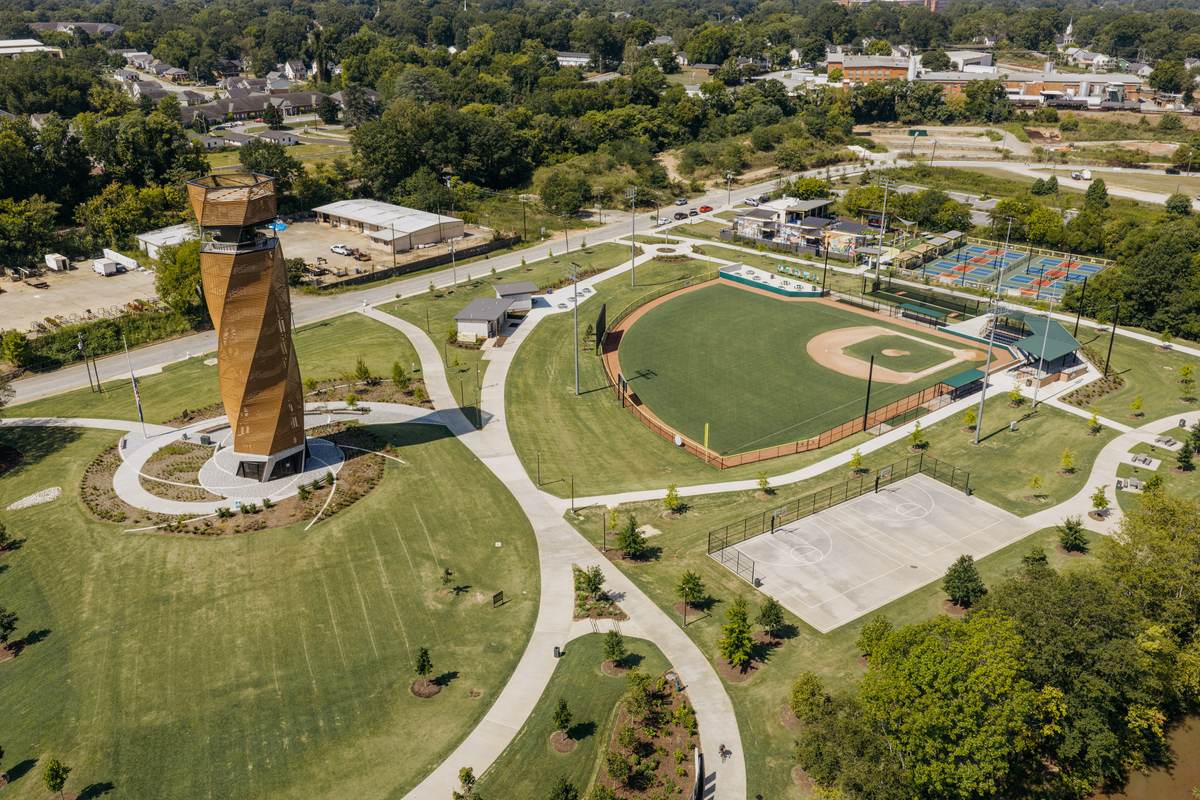 A public park in downtown Greenville from the air: a ball field, courts, lawns and a spiral observation tower.